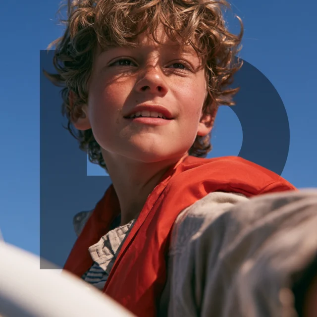 A young sailor out on the water